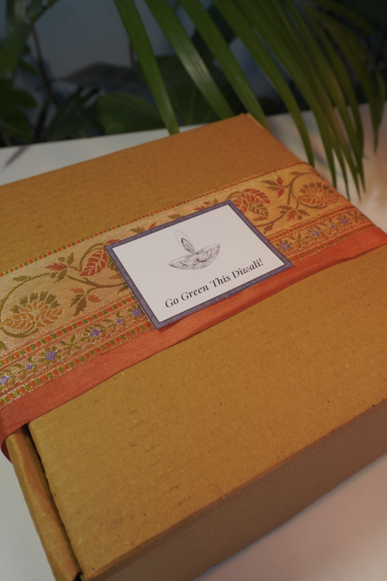 Eco Diwali Gift Box 1 | Upcycled Flower Toran | Soy Candle Jar | Dates Jar with Filling | Coffee & Orange Body Scrub